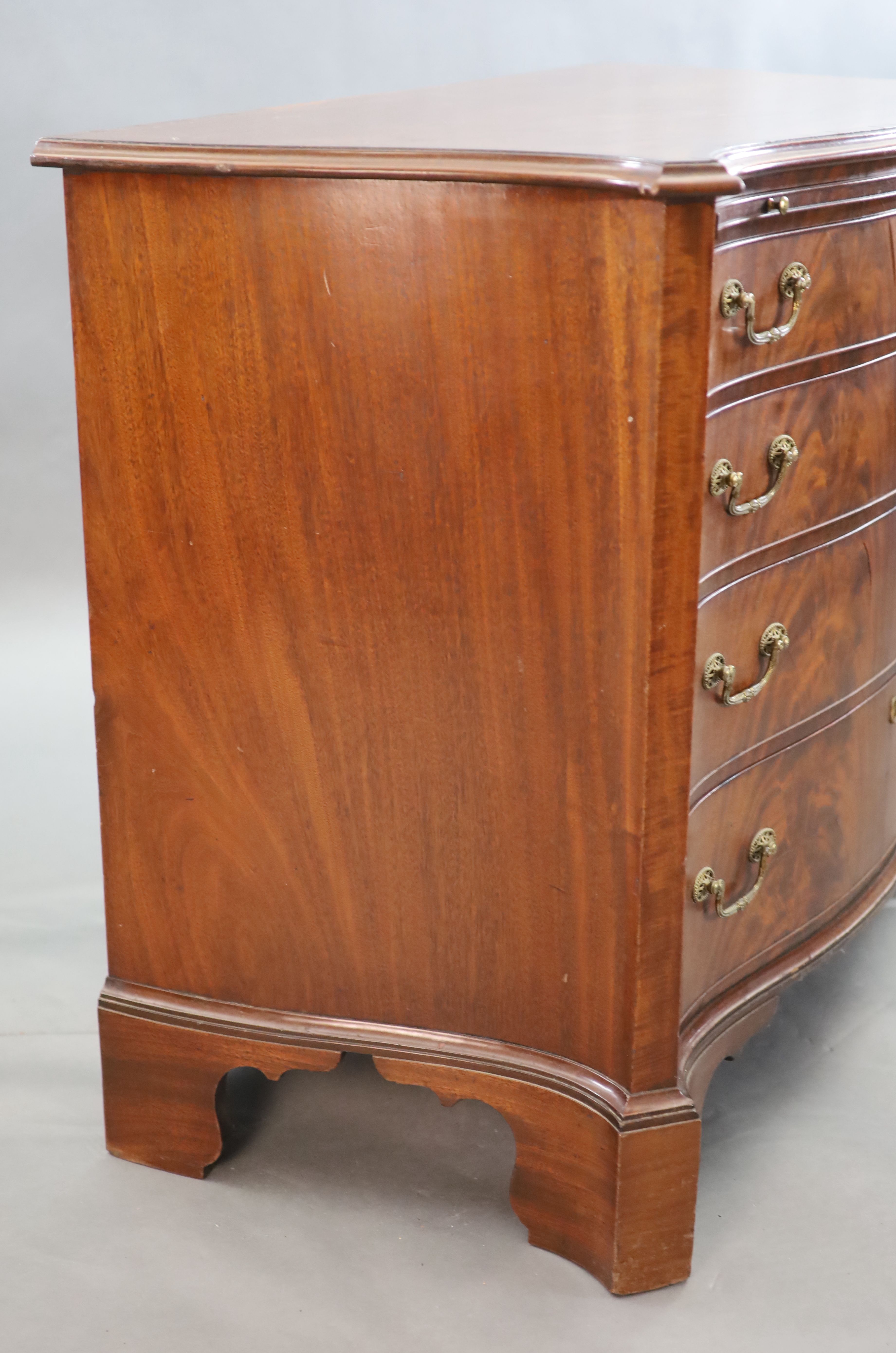 A George III mahogany and rosewood banded serpentine fronted chest, W. 3ft 7in. D. 1ft 10in. H. 2ft 11in.
